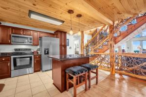 a kitchen with a wooden ceiling and a staircase at Ace of Diamonds in Seven Devils