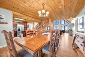 a dining room and kitchen with a wooden table and chairs at Ace of Diamonds in Seven Devils