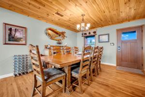 a dining room with a wooden table and chairs at Ace of Diamonds in Seven Devils +26 photos