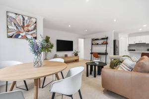 a living room with a couch and a table at Stylish West Hobart Villa in West Hobart