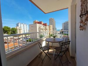 a balcony with a table and chairs and a view of a city at Vistas al mar in Miramar +22 photos
