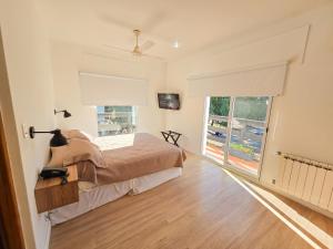 a bedroom with a bed and a large window at Hotel Milton in La Paz