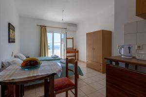 a kitchen and a room with a bed and a table at Nautilus Apartments in Sisi