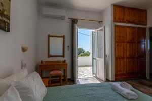 a bedroom with a bed and a desk and a mirror at Nautilus Apartments in Sisi