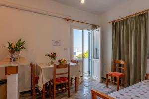 a dining room with a table and chairs and a window at Nautilus Apartments in Sisi +42 photos