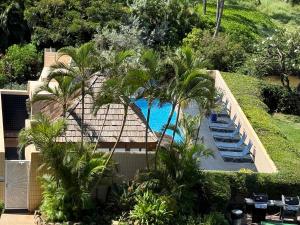 an overhead view of a swimming pool with palm trees at Oceanfront Artist Condo Panoramic Maui Sunsets in Kihei