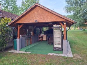 a gazebo with a table and chairs under it at Plaža STEFIN KUTAK in Rudice
