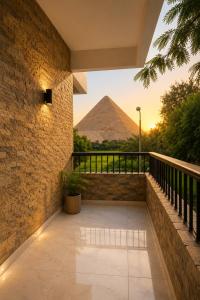 a balcony with a view of the pyramids at Vincci Pyramids View in Cairo
