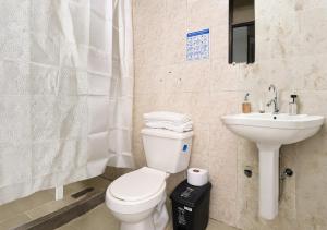 a bathroom with a toilet and a sink at Ocean Blue Suites & Hotel Sm in Santa Marta
