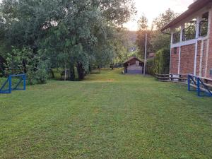 an empty yard next to a brick building at Plaža STEFIN KUTAK in Rudice