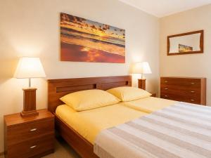 a bedroom with a bed with two nightstands and two lamps at Pensjonat Marynarski - Apartamenty in Darlowko
