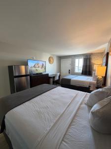a hotel room with two beds and a desk at Extend-a-Suites Phoenix in Phoenix