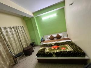a bedroom with a bed in a room with green walls at Wonder View in Shimla +23 photos