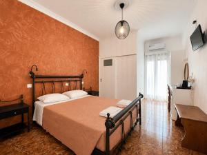 a bedroom with a large bed and a window at Villa Ilios in Fira +38 photos