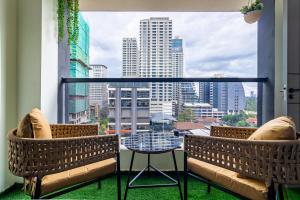 a balcony with a table and chairs and a view of a city at Luxury 1 bedroom in Westlands, Rooftop Pool, Next to Kempinski & GTC, Fast Wifi & Pool Table in Nairobi