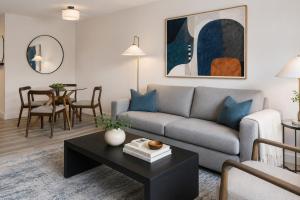 a living room with a couch and a table at Global Luxury Suites at Georgetown in Washington, D.C. +38 photos