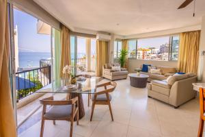 a living room with a view of the ocean at Blue Chairs Beachfront Resort Puerto Vallarta - Adults Only in Puerto Vallarta