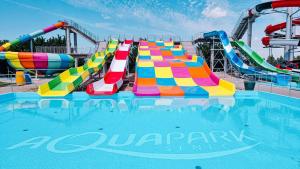 a pool with a water park with a water slide at Villa La Pollo in Senec