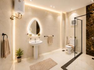 a bathroom with a sink and a toilet and a mirror at Vincci Pyramids View in Cairo