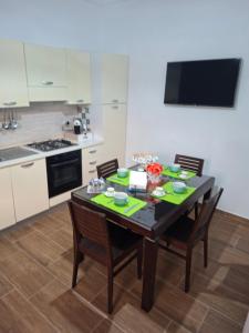 a kitchen with a table and chairs in a kitchen at Don Pedro Home in Naples