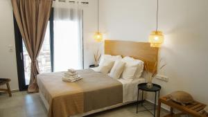 a bedroom with a large bed with white pillows at One Lemnos luxury Apartments in Lemnos