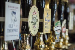 a bunch of bottles of wine on a shelf at Scotsman's Pack Hotel in Hathersage +28 photos