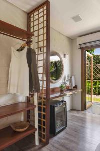 a room with a kitchen with a stove and a mirror at Odoyá Casa Hotel in Paraty