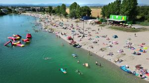 a group of people on the beach at a beach at Villa La Pollo in Senec