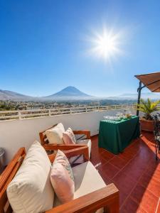 a living room with couches and a table on a balcony at Natura Inn Hotel in Arequipa