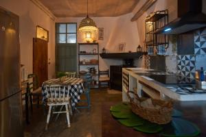 a kitchen with a table and a dining room at Casa Cercana in Abarán +26 photos