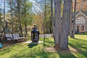 a large black vase sitting next to a tree at Waterfront with VIEW and SPA in Saint-Raymond +52 photos