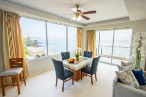 a dining room with a view of the ocean at Blue Chairs Beachfront Resort Puerto Vallarta - Adults Only in Puerto Vallarta