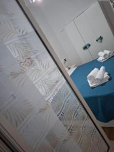 a room with a bed with a glass window at Don Pedro Home in Naples