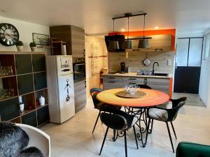 a kitchen with a table and chairs and a refrigerator at Le Gîte de Brigitte ! in Saint Die +29 photos