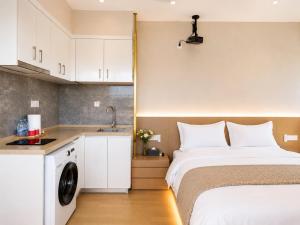 a small bedroom with a bed and a sink at Ancient City Garden Luxury Residence Xian in Xi'an +42 photos