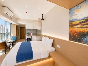a bedroom with a bed and a painting on the wall at Ancient City Garden Luxury Residence Xian in Xi'an