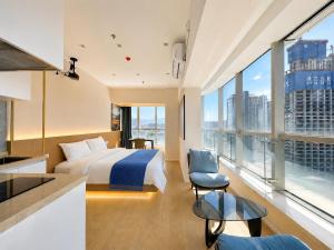 a hotel room with a bed and a large window at Ancient City Garden Luxury Residence Xian in Xi'an
