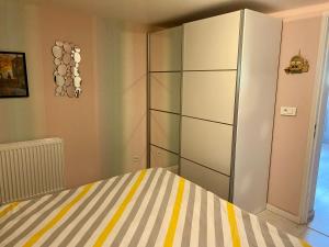 a bedroom with a bed and a large cabinet at Le Gîte de Brigitte ! in Saint Die