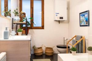 a kitchen with a sink and a toilet in a room at Apartamento junto al Ayuntamiento - by wehomes in Santander