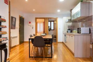 a kitchen with a table and chairs in a room at Apartamento junto al Ayuntamiento - by wehomes in Santander +29 photos
