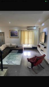 a living room with a couch and a chair at Sandvica Luxe Homes in Port Harcourt