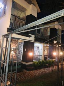 a house with a balcony with lights on it at Sandvica Luxe Homes in Port Harcourt