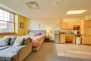a bedroom with a bed and a couch and a kitchen at Work, Play & Explore: 9-Unit New Kensington Base in New Kensington