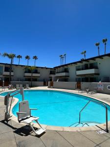 a large swimming pool with a chair at Winners Circle Solana Beach Del Mar Resort in Solana Beach
