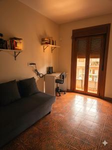 a living room with a couch and a desk at A Veiga Grande in Pontevedra +5 photos