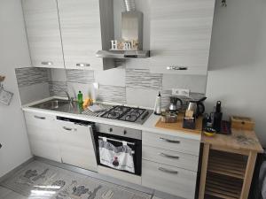 a small kitchen with a stove and a sink at La Casa di Nonna Mari in Moneglia