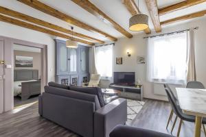 a living room with a couch and a table at La Curiosité in Barr