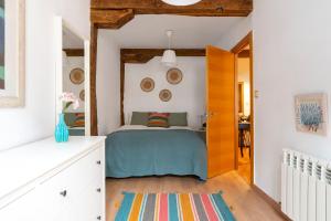a bedroom with a bed and a wooden door at Apartamento junto al Ayuntamiento - by wehomes in Santander