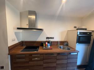 a kitchen with a sink and a counter top at Central Sheffield Studio for 2 in Sheffield