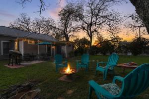 a group of chairs sitting around a fire in a yard at Austin Haus in Fredericksburg